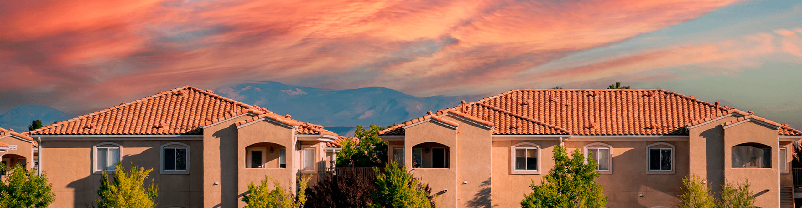 New mexico houses and a pink sunset above