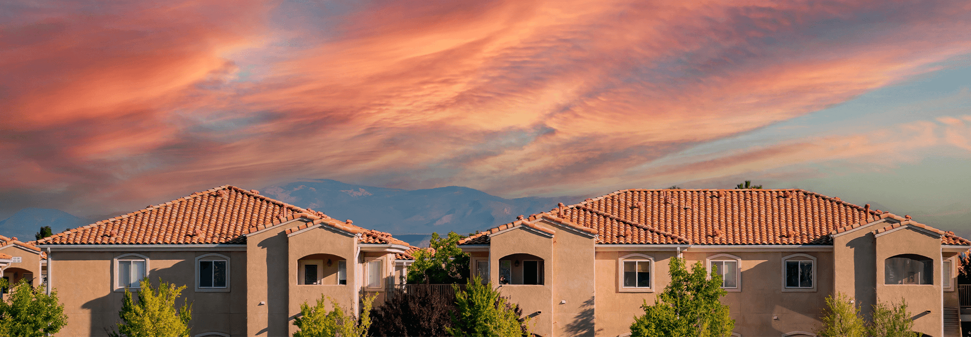 New mexico houses and a pink sunset above