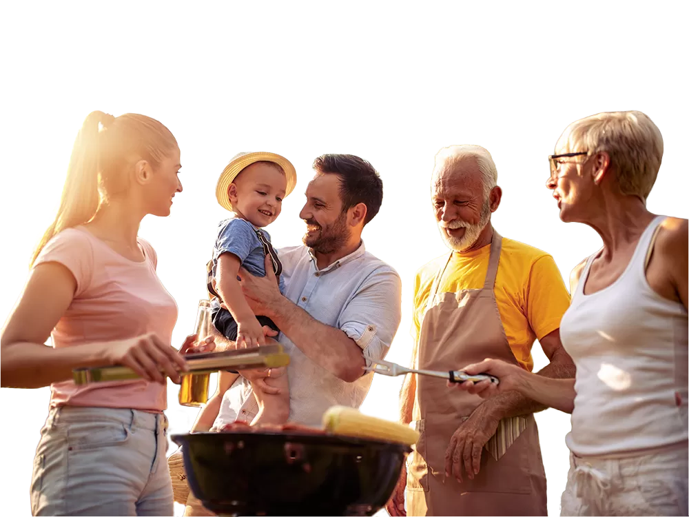 4 person family talking and barbecuing in the sunset