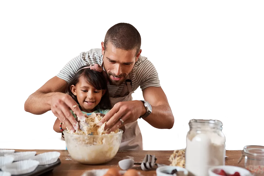 dad and daughter mix ingredients in a bowl for baking