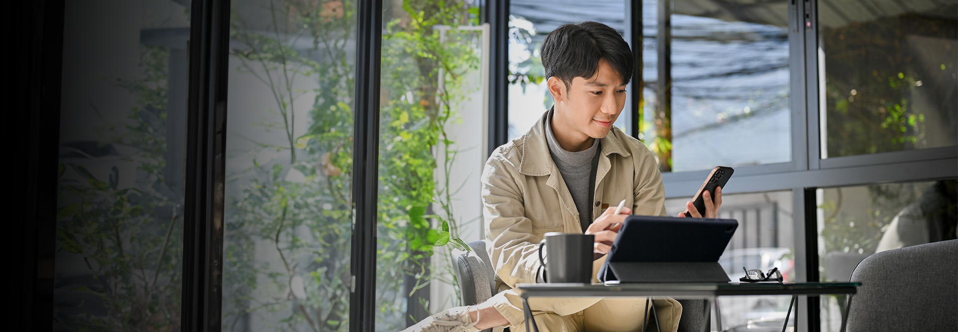 man on his phone at a coffee shop