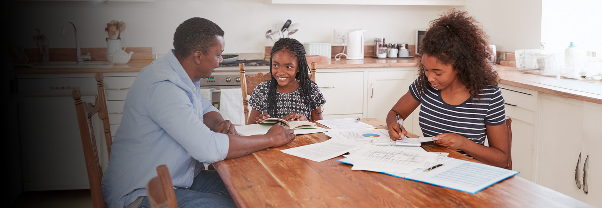 family at kitchen table doing homework