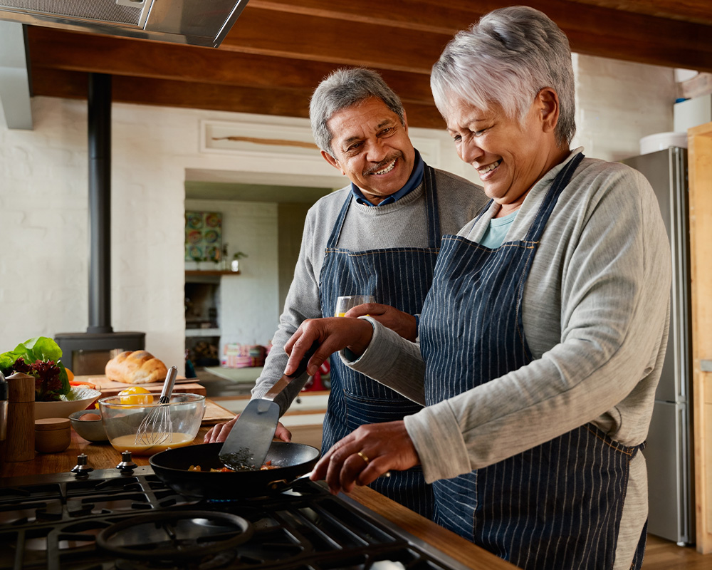 older man and woman cooking together