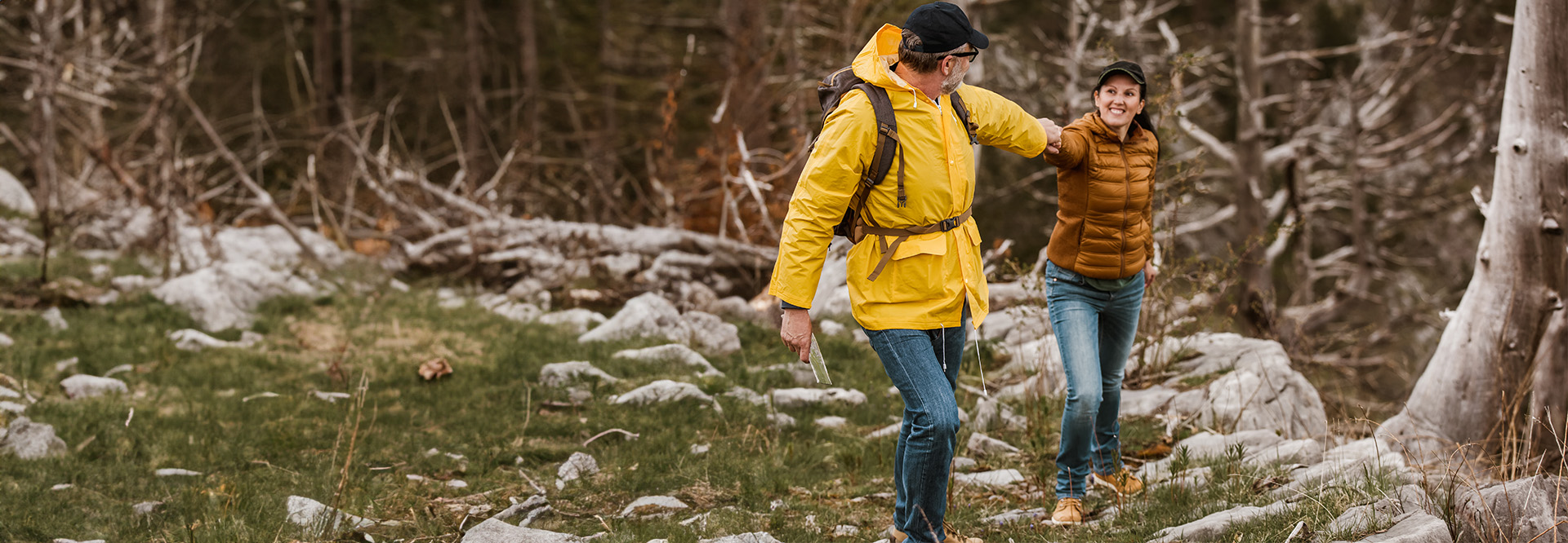 older man and woman hiking in the mountains