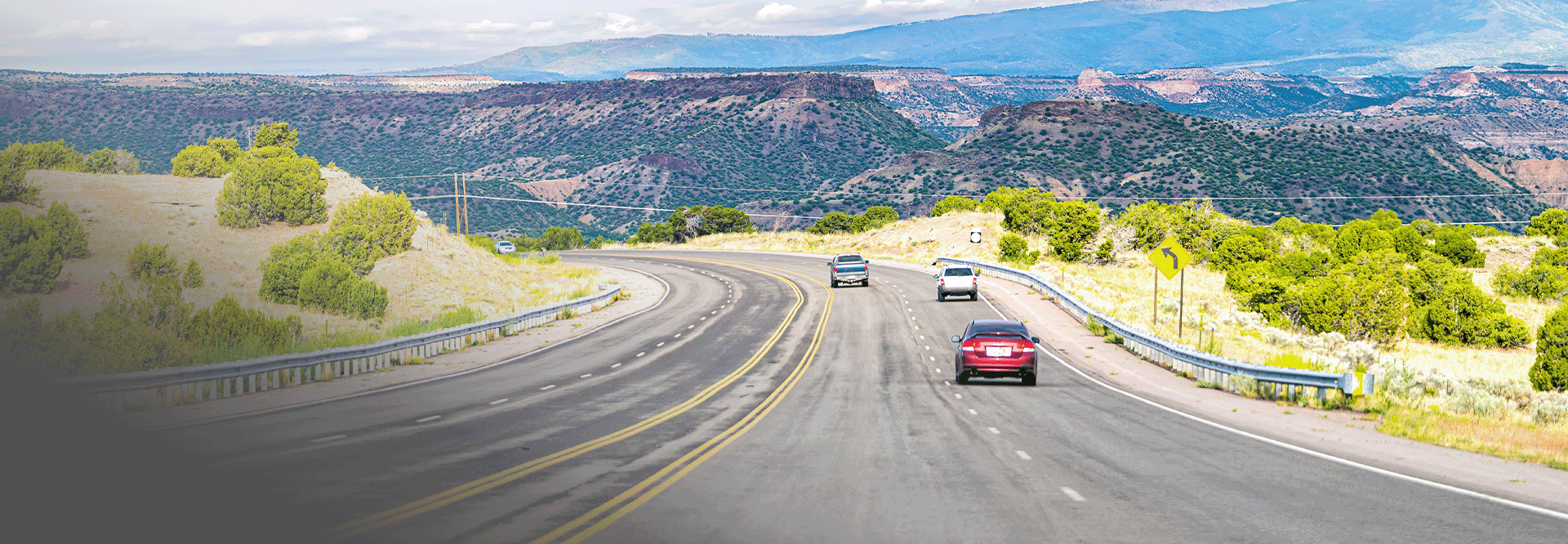 vehicles driving on freeway with sandia mountains in view