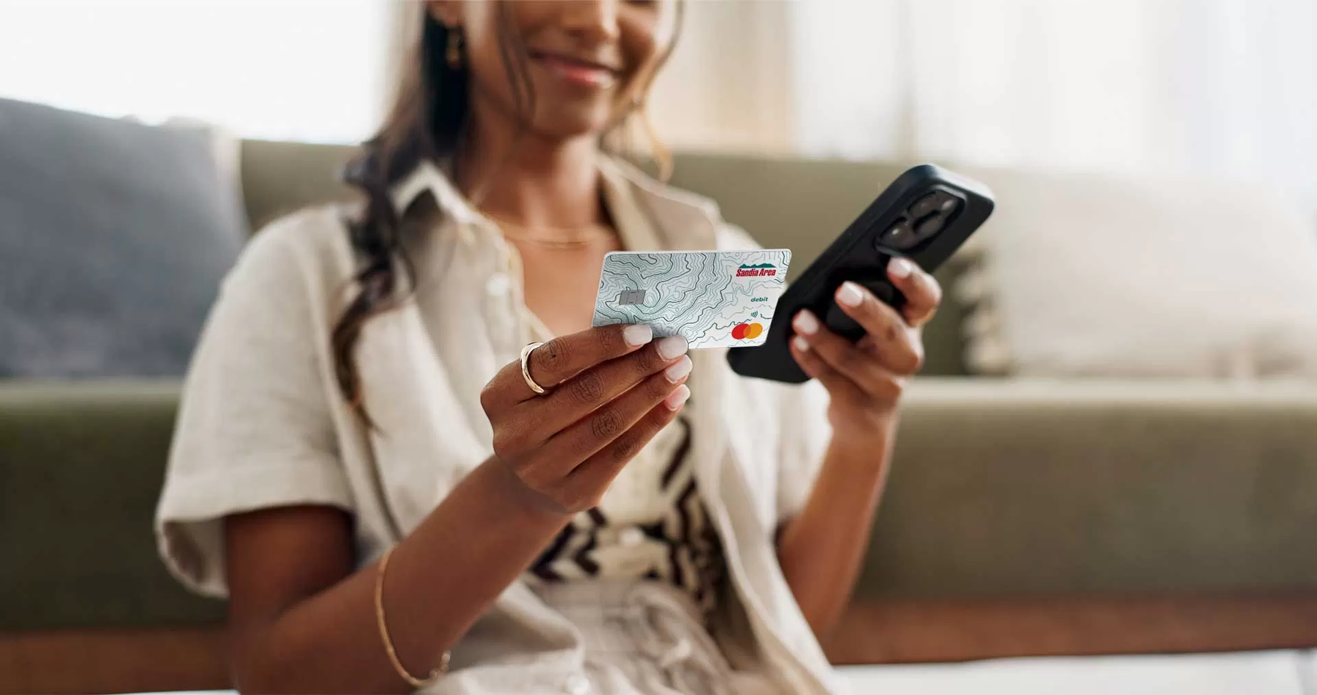 woman looking at debit card