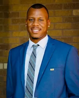 Chad Adams headshot wearing a blue suit
