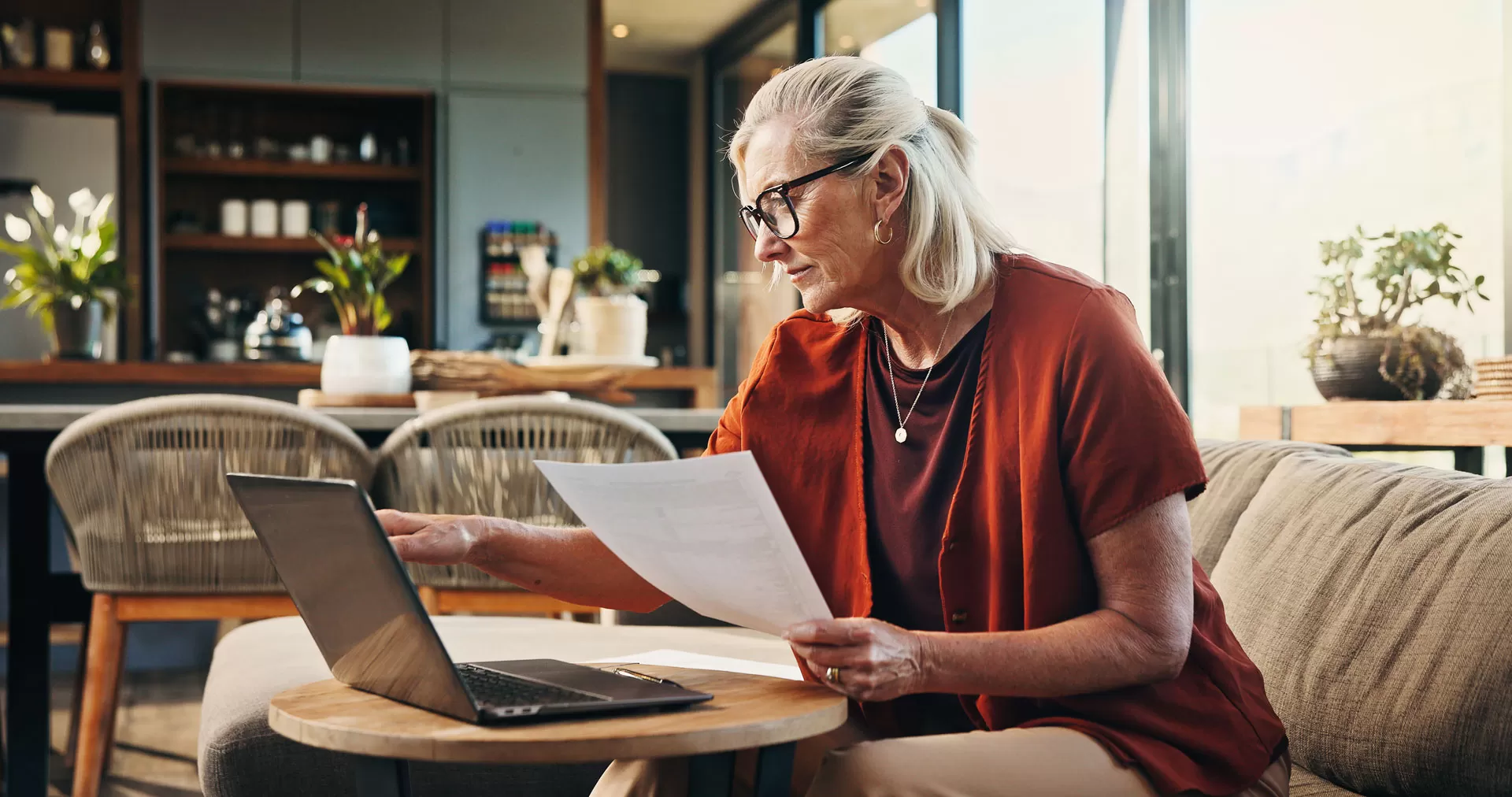 Elderly woman looking at computer and retirement planning