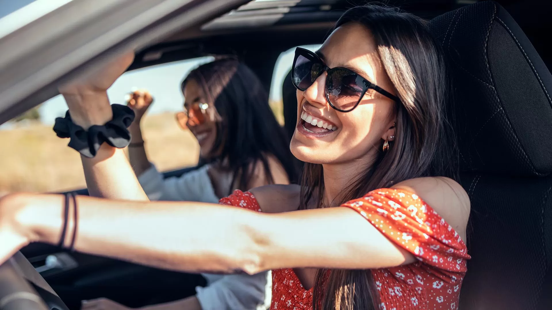 woman smiling driving in car